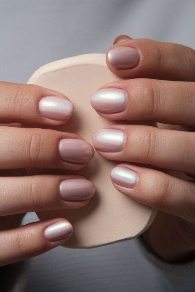 Milky white oval nails, two hands in soft light, builder gel manicure over 50