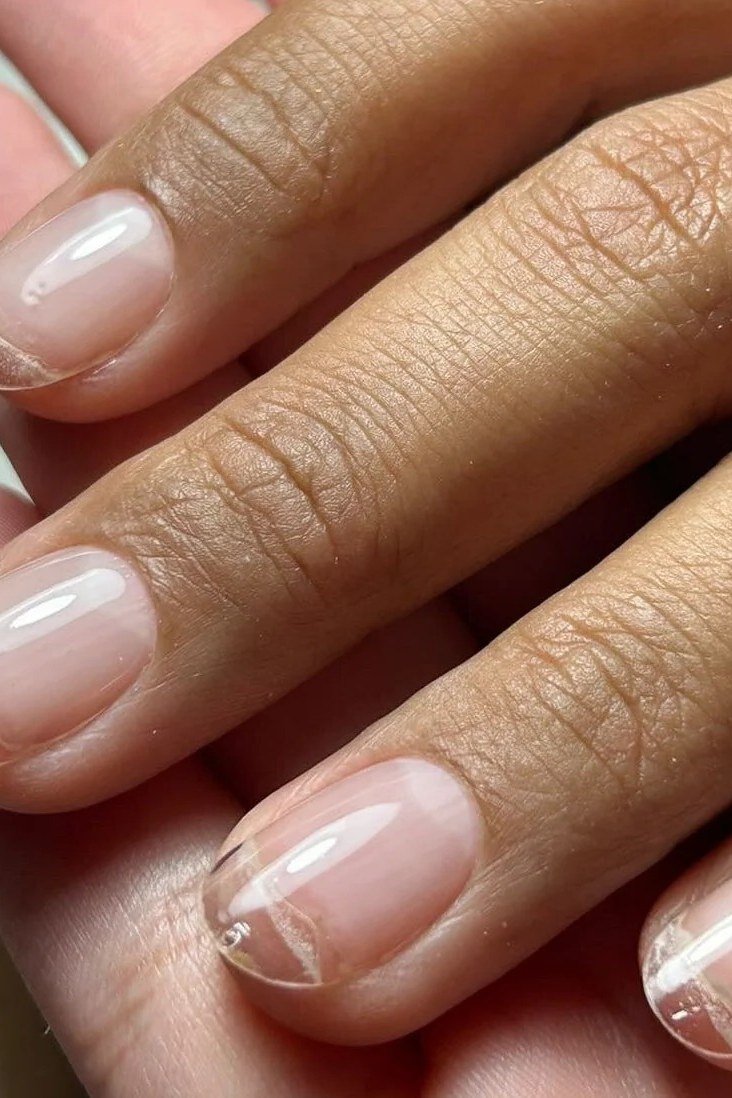 Clear natural builder gel overlay on dark skin hand with almond nails
