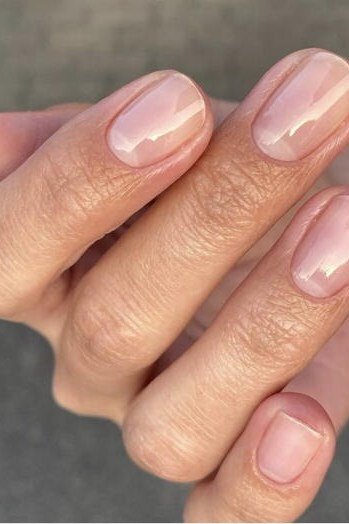 Sheer nude nails in relaxed hand pose, natural builder gel overlay