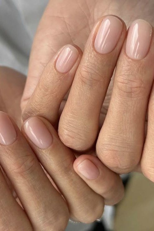 Nude oval nails, two hands together, builder gel manicure over 50