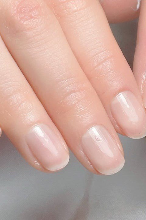 Sheer nude nails, two hands, minimal builder gel manicure for women over 50