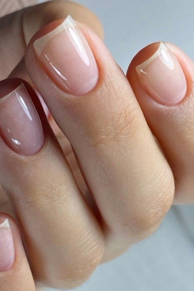 Pinky-nude almond nails close-up, natural builder gel overlay