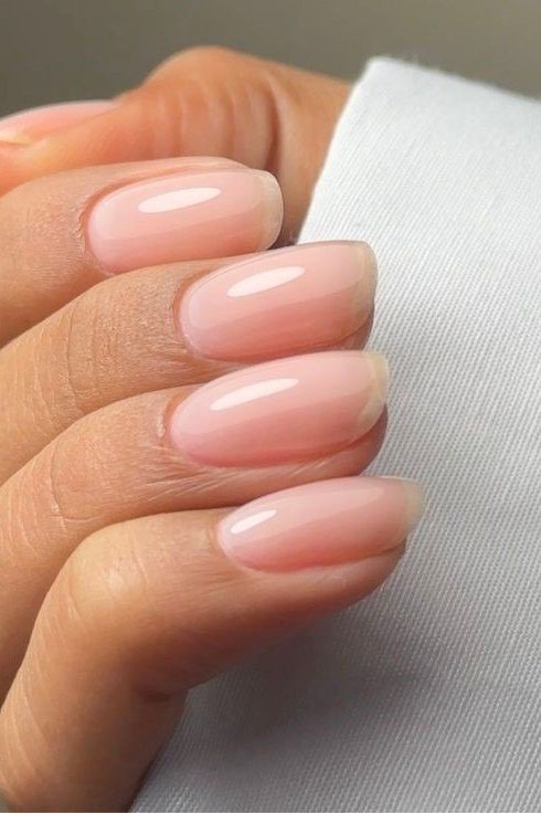 Pinky-nude oval nails close-up, builder gel manicure for women over 50