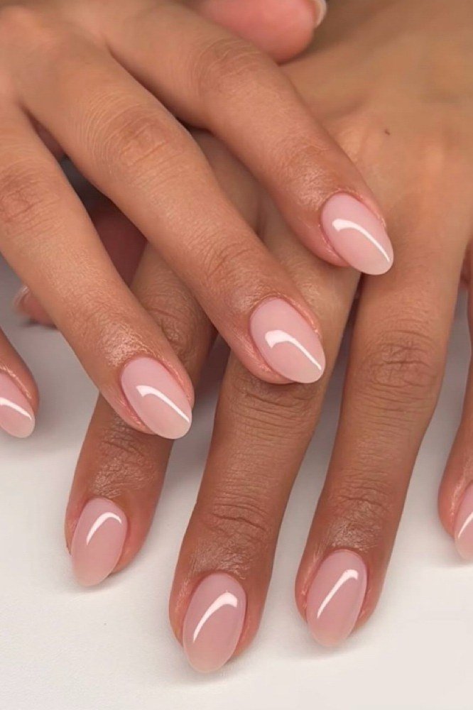 Pink-nude almond nails, two hands on white, builder gel manicure over 50