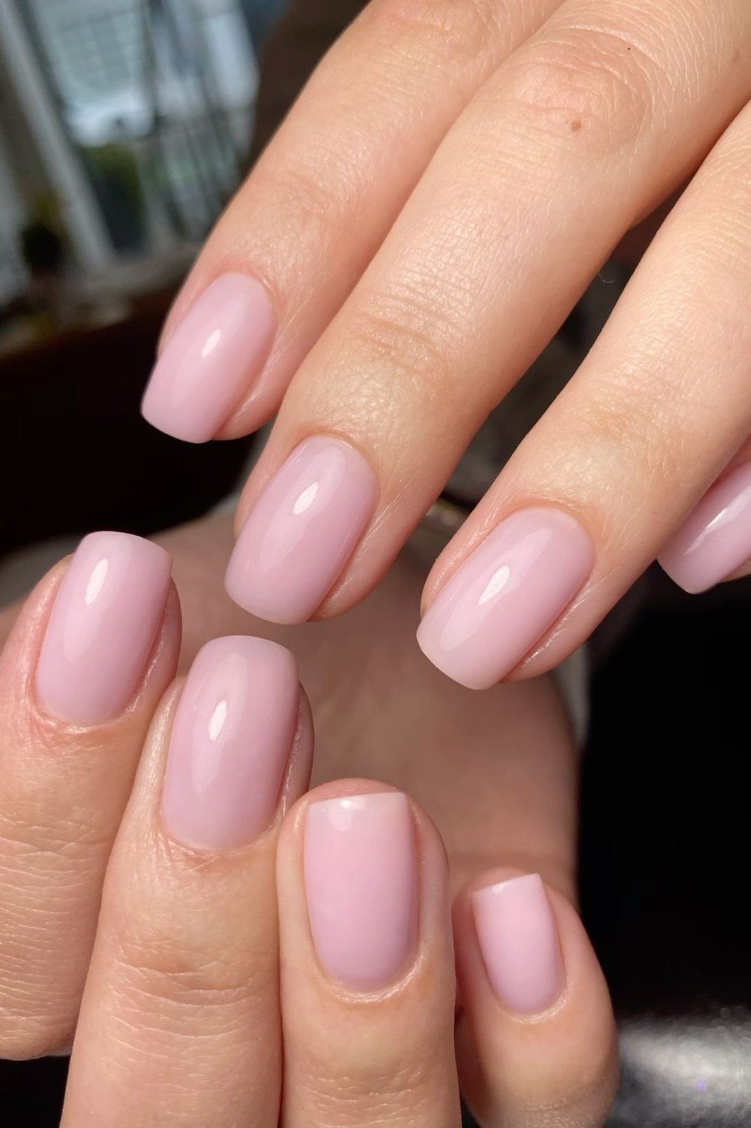 Pink oval nails, two hands in soft light, builder gel manicure over 50