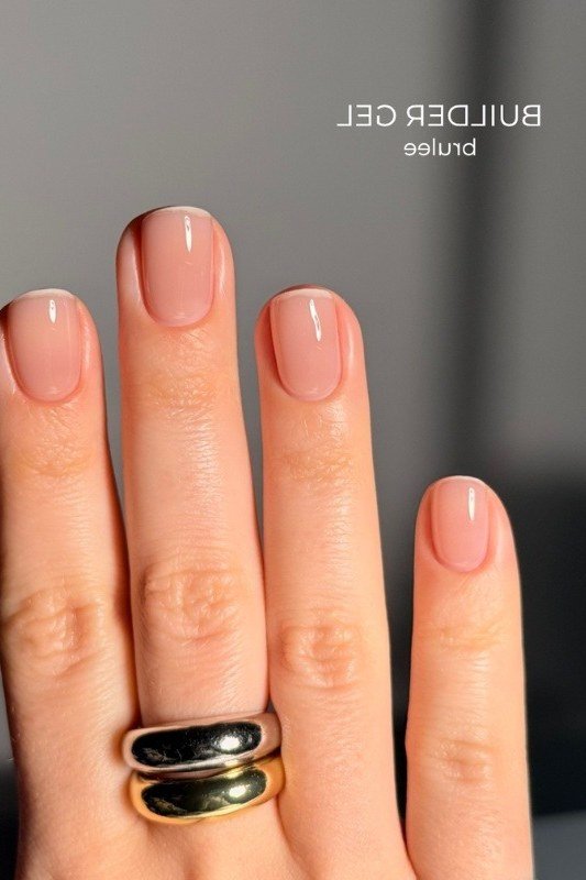 Short nude square nails with rings, builder gel manicure for women over 50