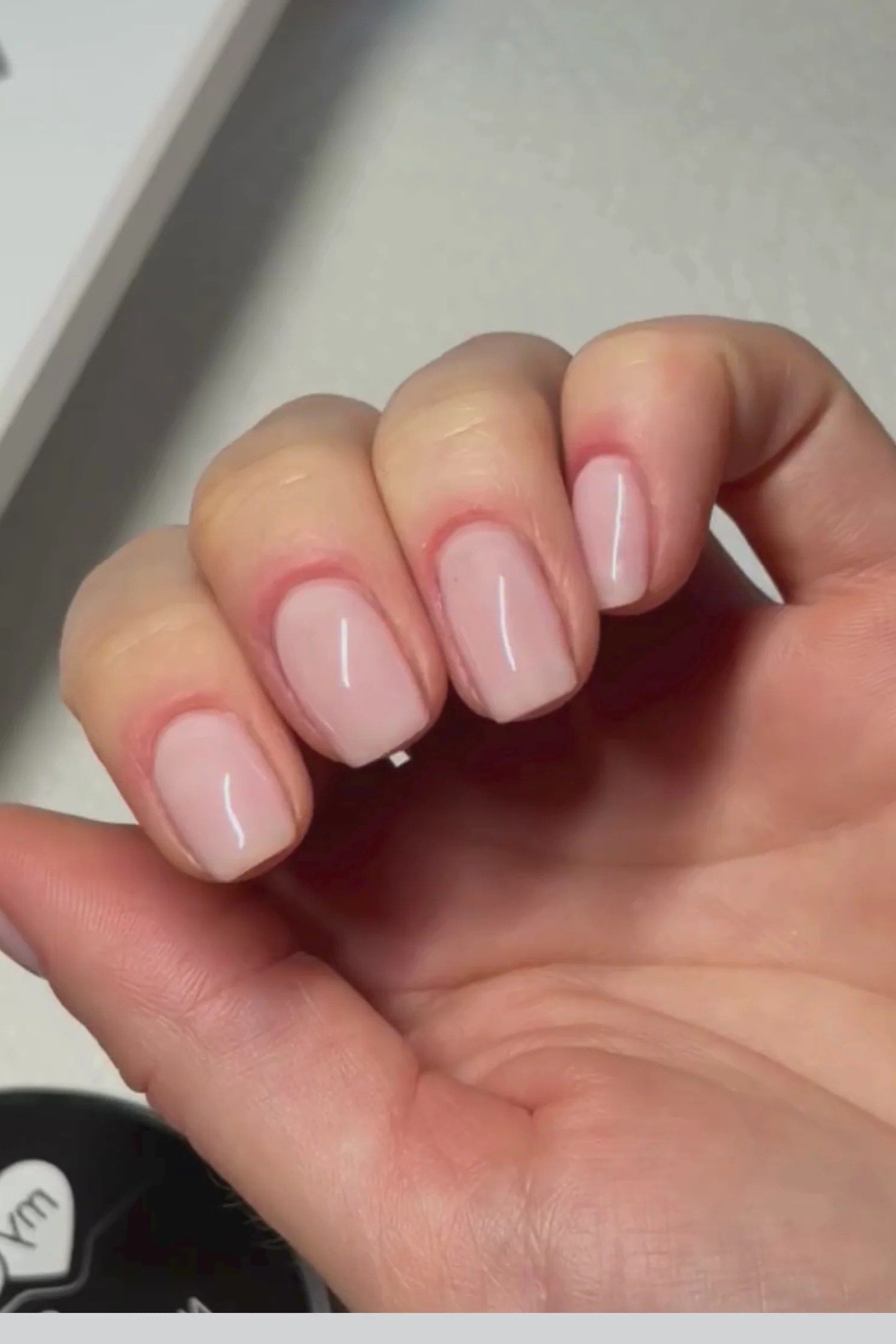 Short nude nails in relaxed hand pose, builder gel manicure over 50