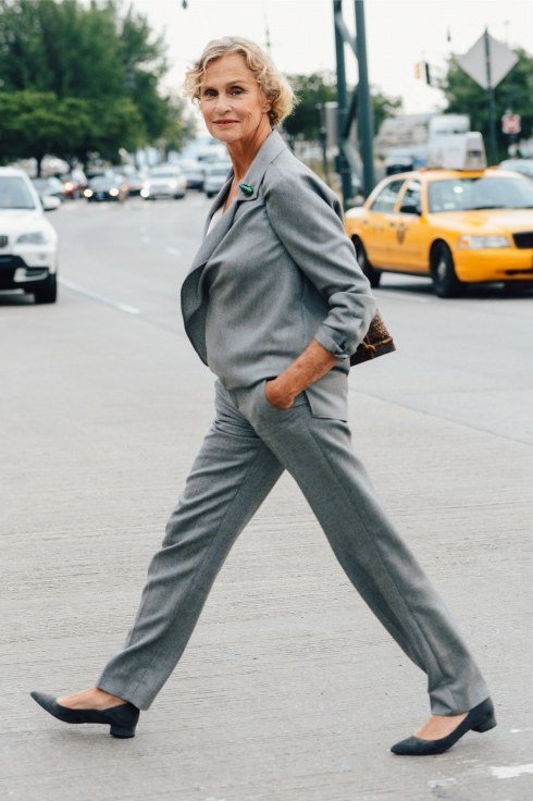 gray blazer suit outfit for women over 50 walking on a city street