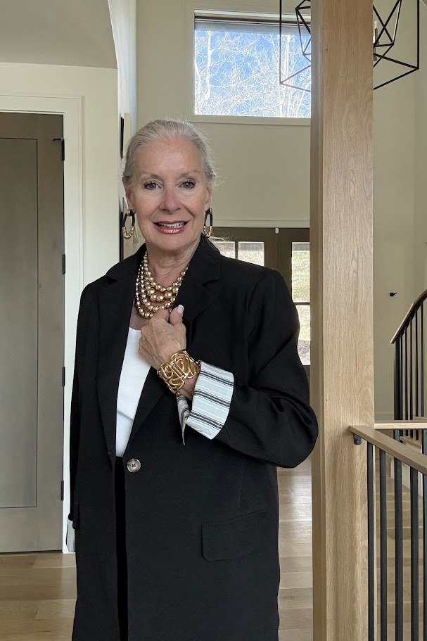 black blazer with striped cuffs and gold jewelry for older women