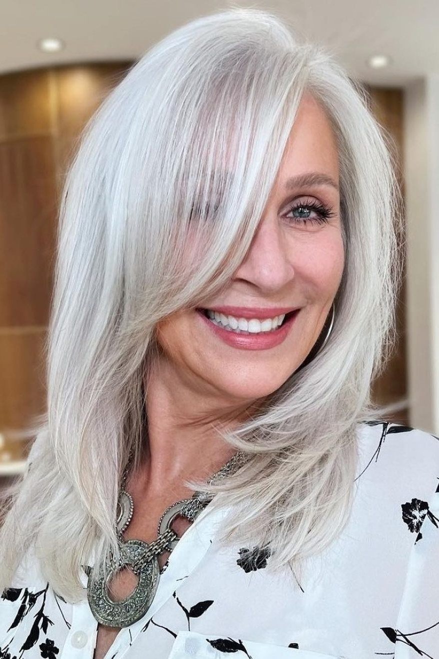 White Blowout with Long Layers - shoulder-length blowout hairstyle for women over 60