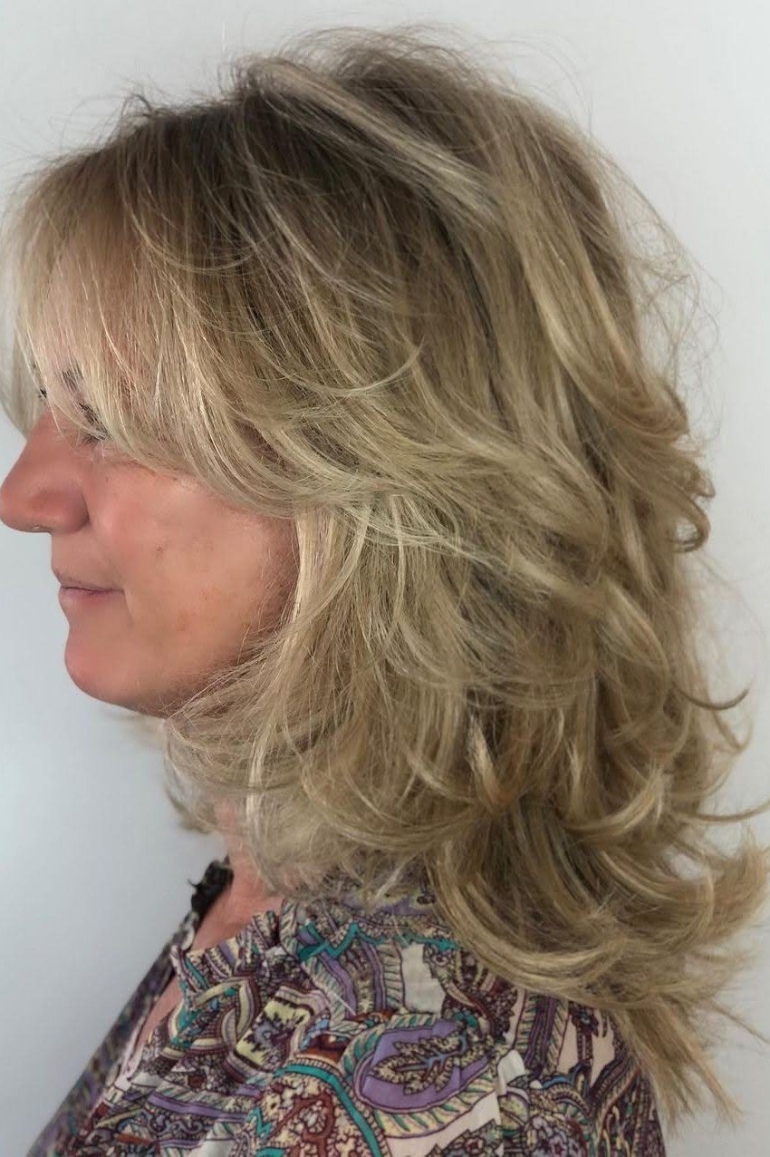 Blonde Layered Blowout - shoulder-length blowout hairstyle for women over 60