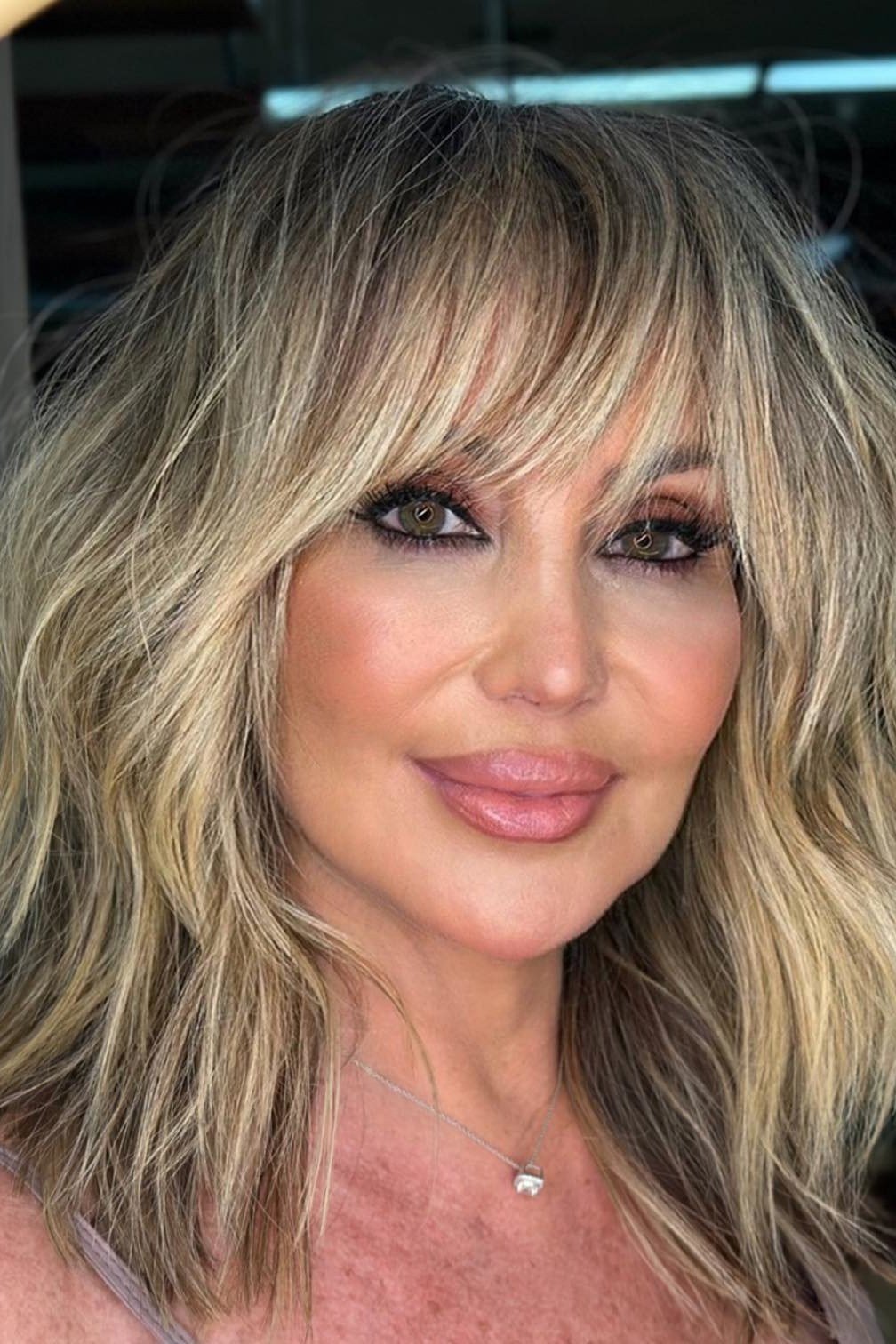 Blonde Shag Blowout - shoulder-length blowout hairstyle for women over 60