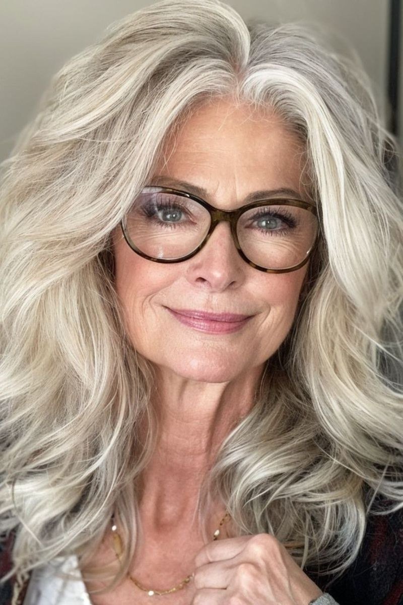 White Wavy Blowout with Glasses - shoulder-length blowout hairstyle for women over 60
