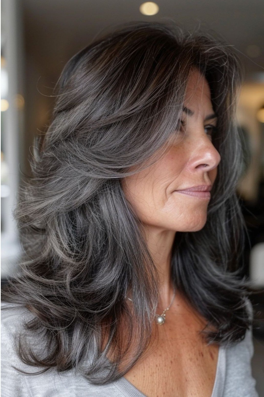 Gunmetal Grey Wavy Blowout - shoulder-length blowout hairstyle for women over 60