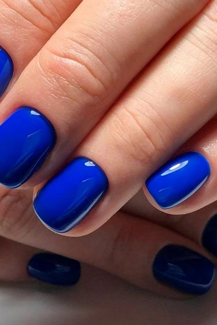 Cobalt blue rounded nails with a diamond ring for women over 50