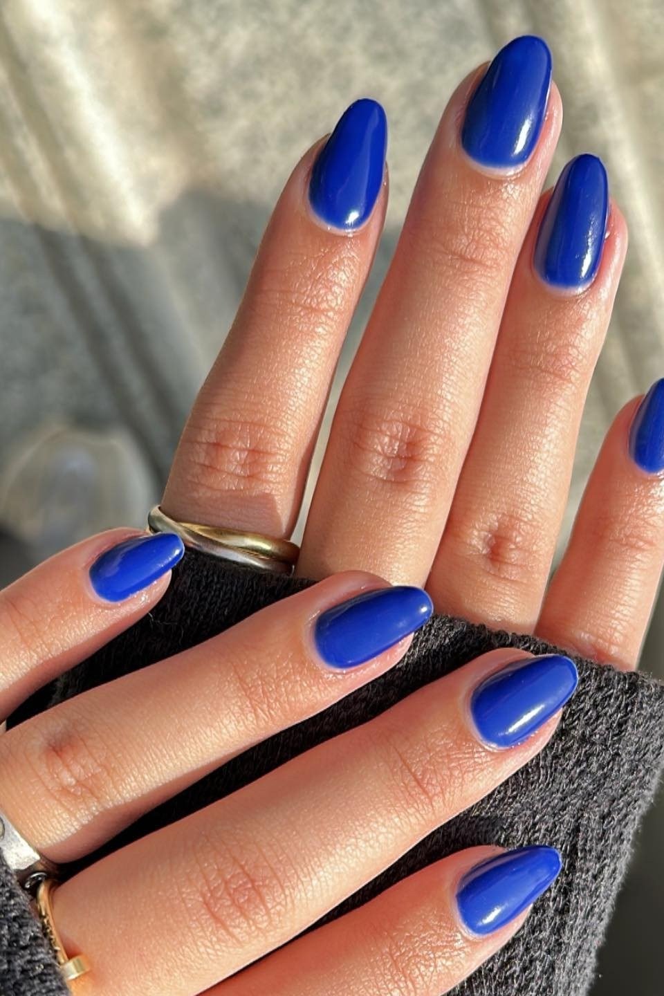 Royal blue almond nails with gold rings for women over 50