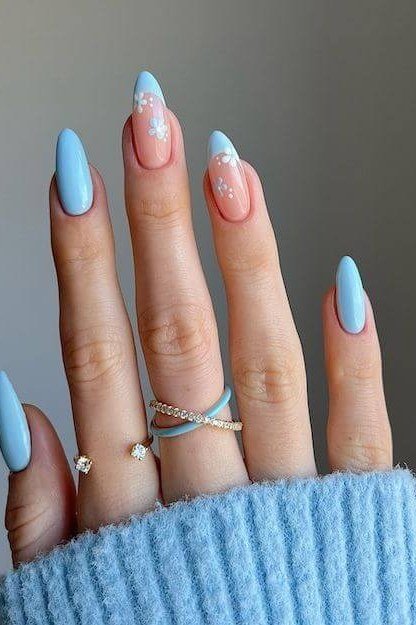 Light blue almond nails with gold rings for women over 50