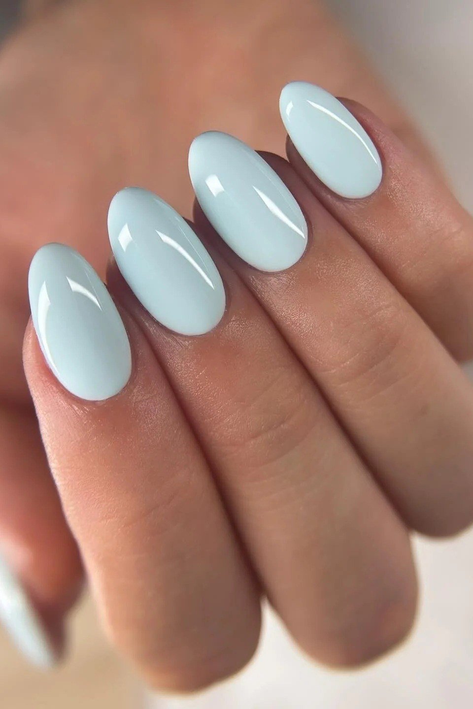 Pale blue oval nails close-up for women over 50