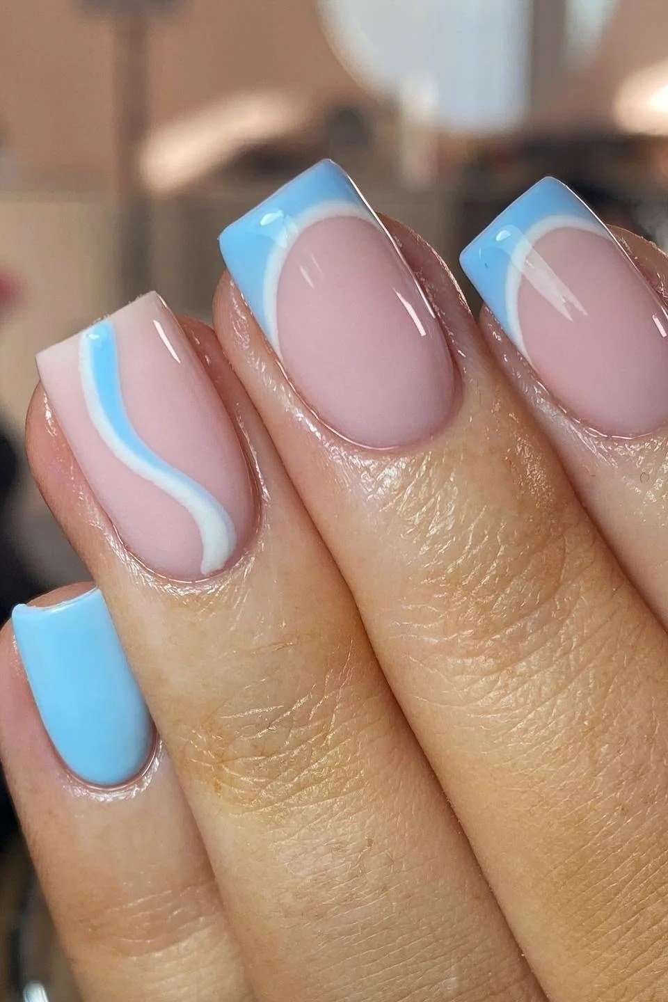 Nude square nails with blue swirl french tips for women over 50