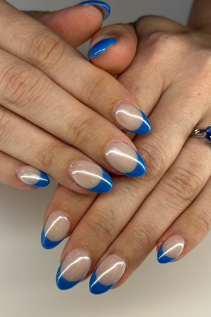 Nude almond nails with royal blue french tips for women over 50