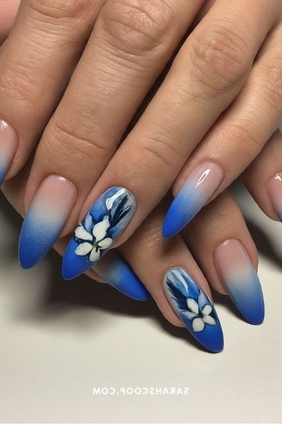 Blue ombre nails with white daisy nail art for women over 50