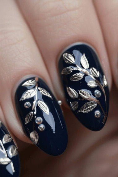 Navy nails with silver floral nail art for women over 50