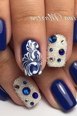 Navy nails with jeweled and ornate silver art for women over 50