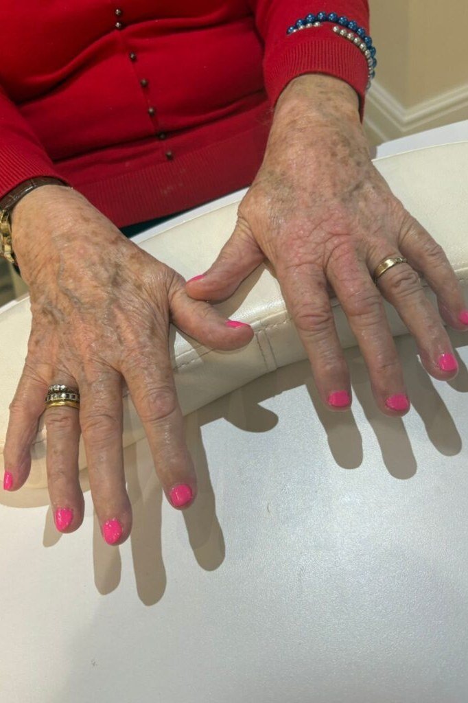 Coral Pink Glossy Nails - flattering nail color for women over 70 on mature hands