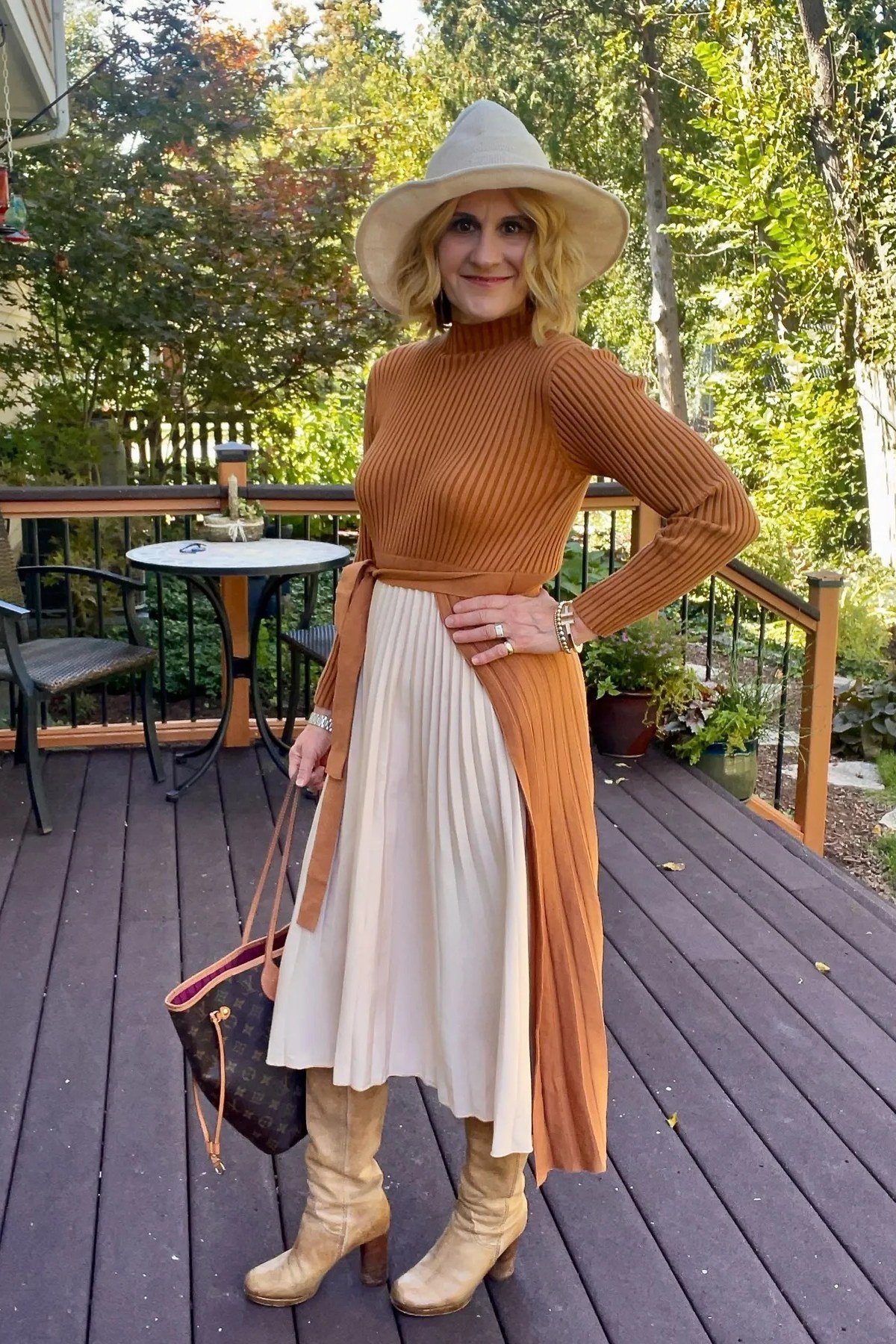 Rust turtleneck with cream pleated skirt and hat casual outfit for women over 40