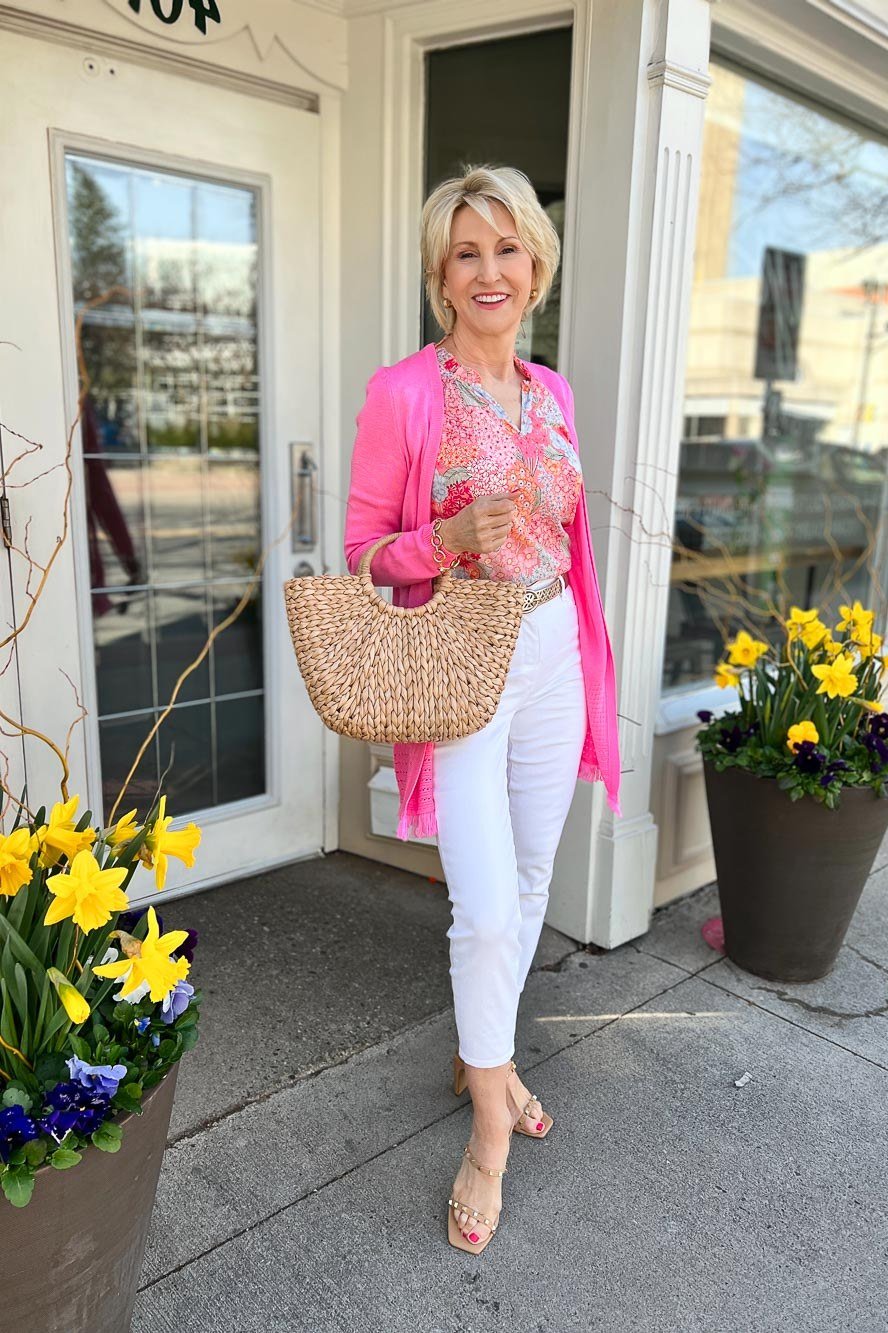 Pink cardigan, white capris, straw tote, storefront, casual outfit for women over 50