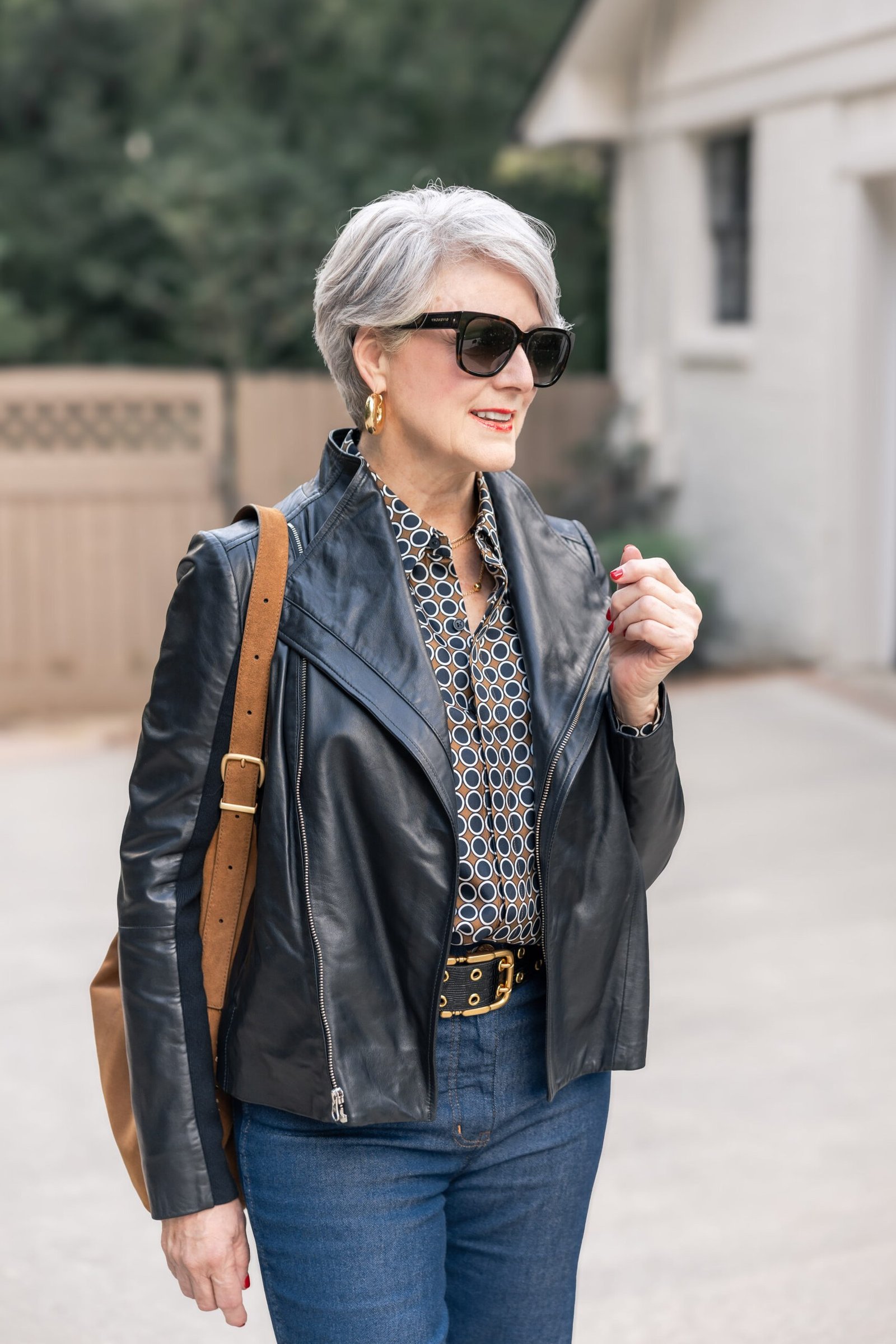 Black leather jacket, printed blouse, jeans, sunglasses, casual outfit for women over 50