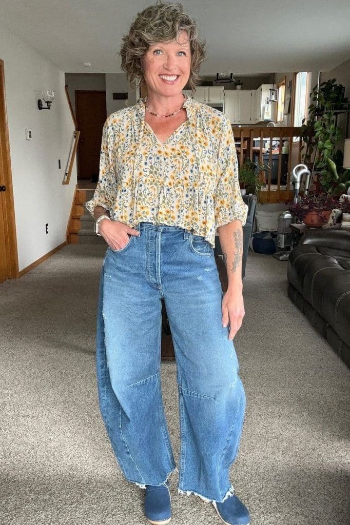 Yellow floral blouse, wide-leg light jeans, hallway, casual outfit for women over 50