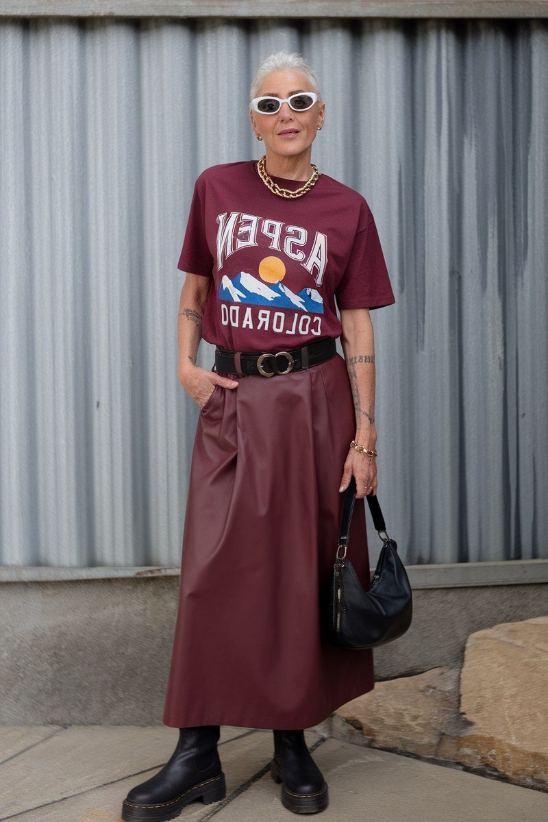 Red Aspen graphic tee, burgundy satin midi skirt, black boots, black bag, casual outfit for women over 50