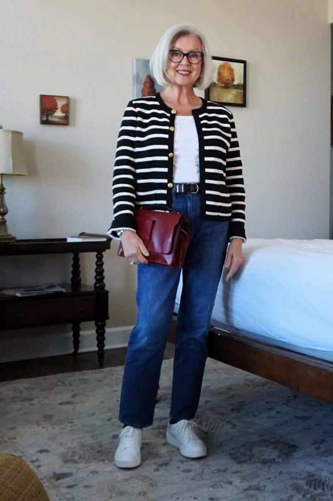 Black/white striped blazer, jeans, red handbag, bedroom, casual outfit for women over 50