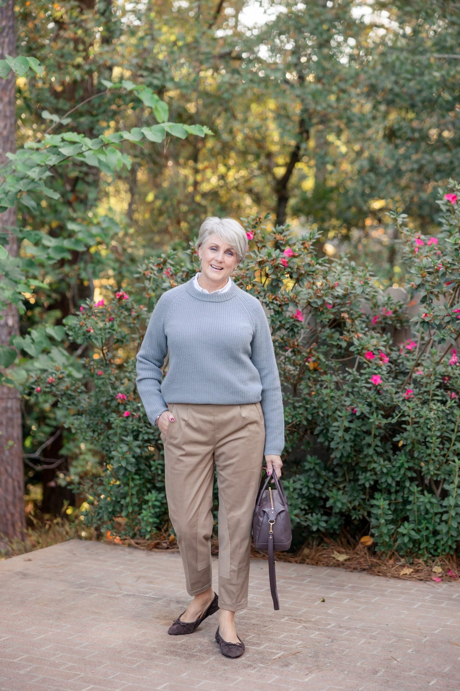 Gray Sweater with Beige Trousers in the Garden - classy fall outfit idea for women over 50