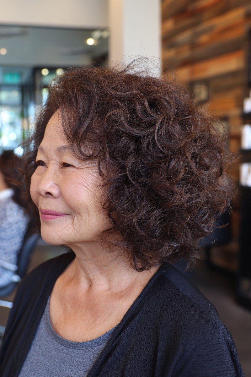 Dark brown curly bob for women over 70