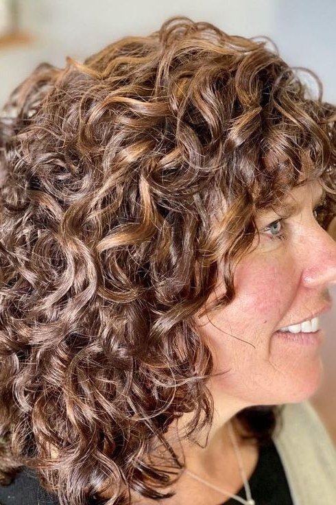 Copper-brown curly bob for women over 70