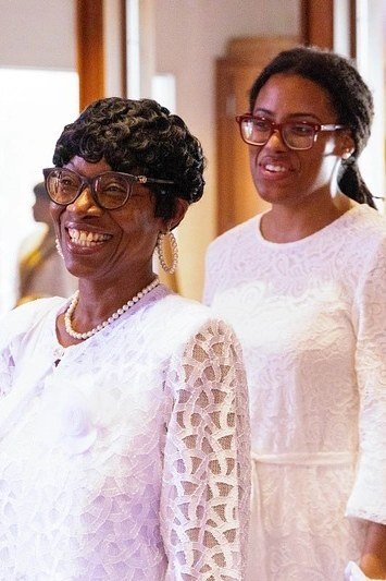 church dresses for women over 60: older woman in matching white lace midi dresses for friends