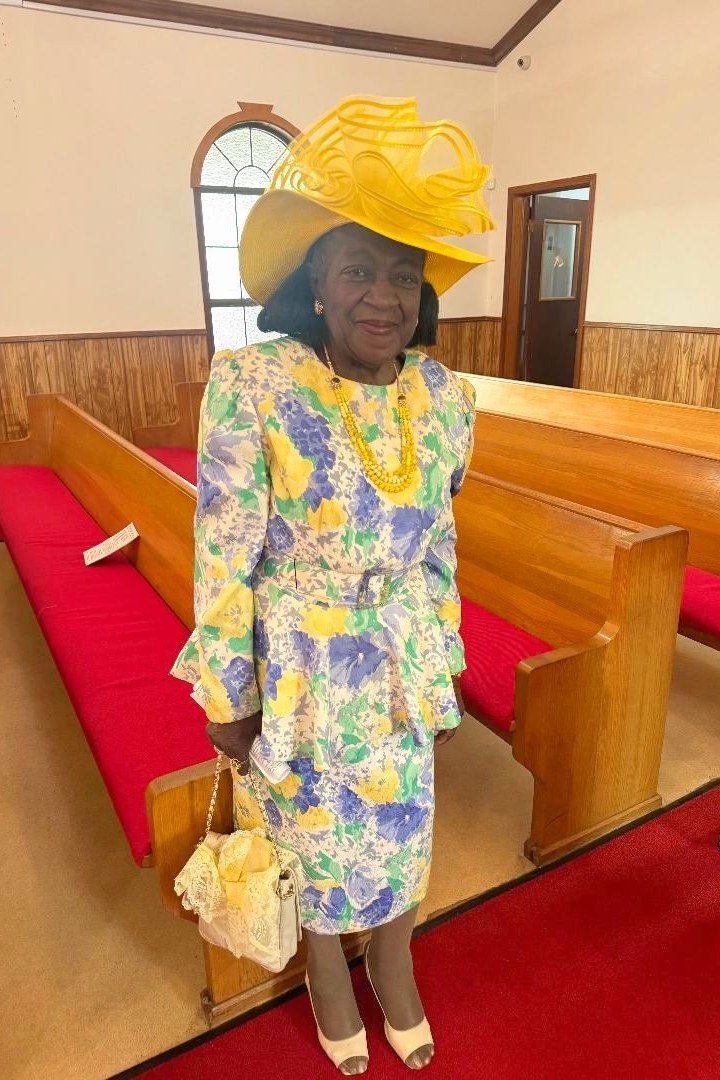 church dresses for women over 60: older woman in floral peplum suit with yellow church hat