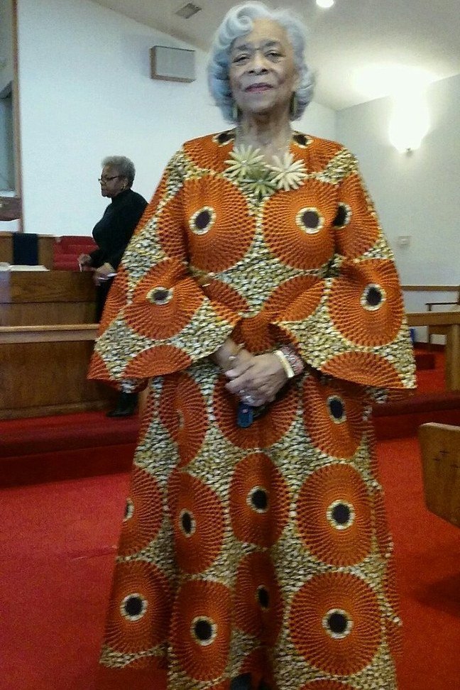 church dresses for women over 60: older woman in orange african wax print maxi