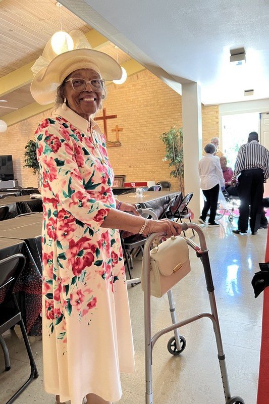 church dresses for women over 60: older woman in red blossom cream maxi with peter pan collar