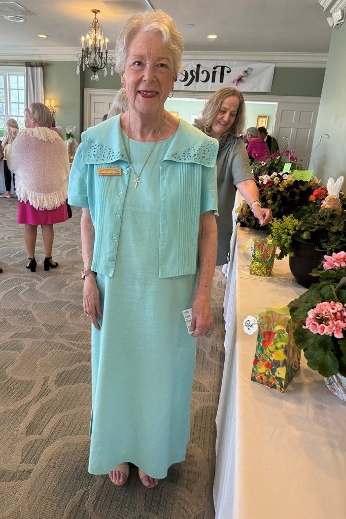 church dresses for women over 60: older woman in aqua midi dress with cropped cardigan