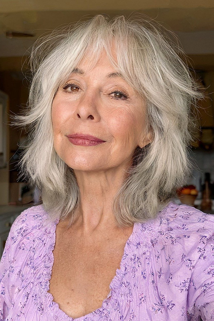 Feathered silver choppy bob haircut for older women