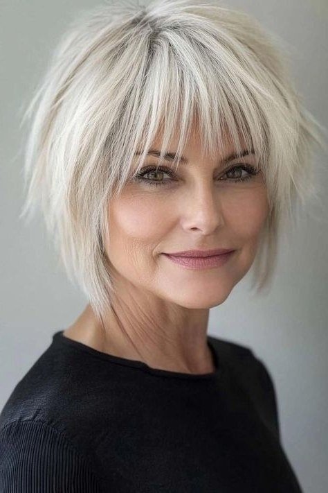 Bold platinum choppy bob with bangs for women over 70
