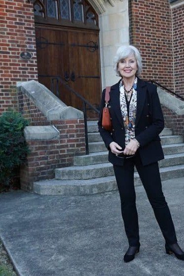 Black pantsuit with red patterned scarf, brick church for women over 60