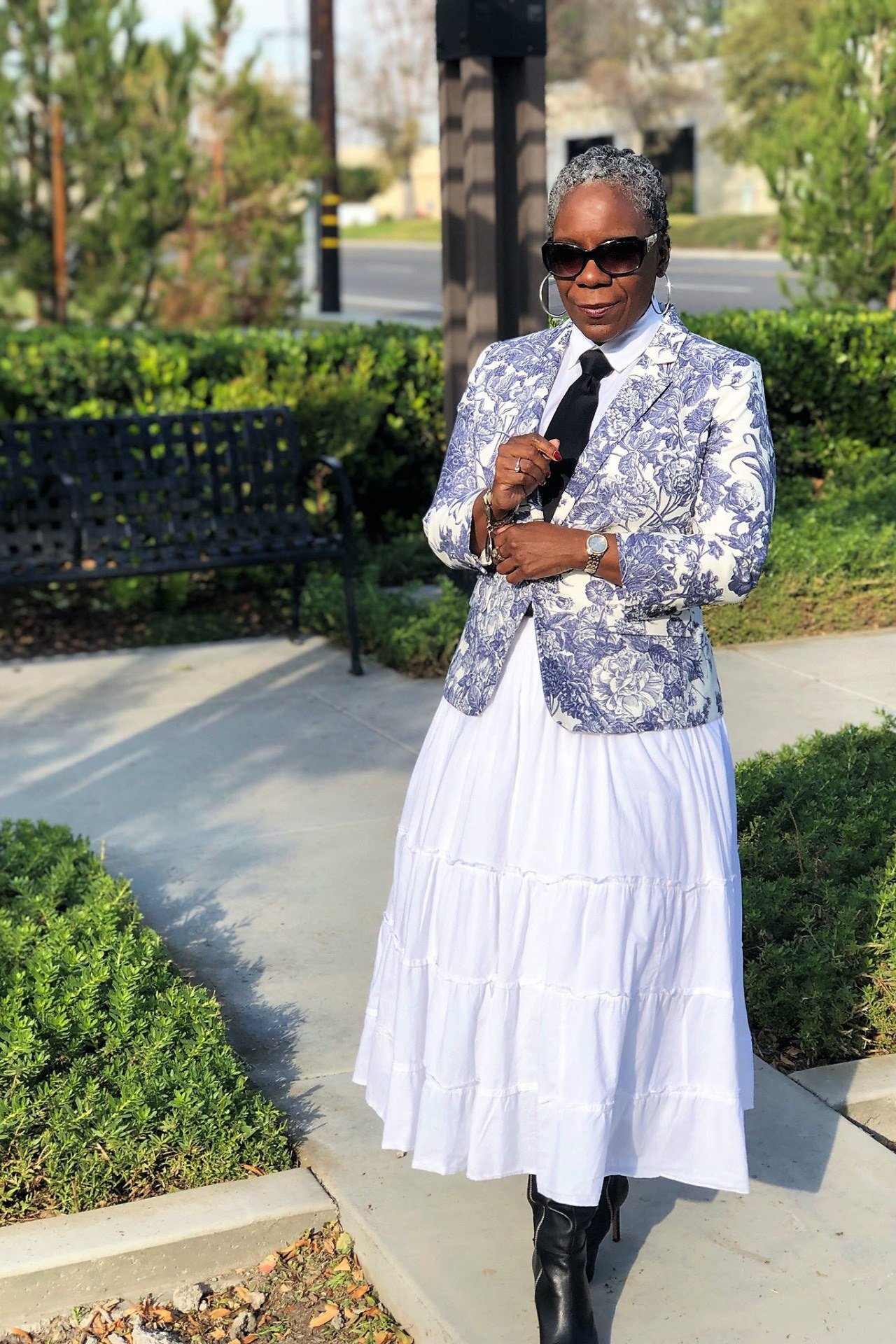 White tiered maxi skirt with patterned blazer, park for women over 60