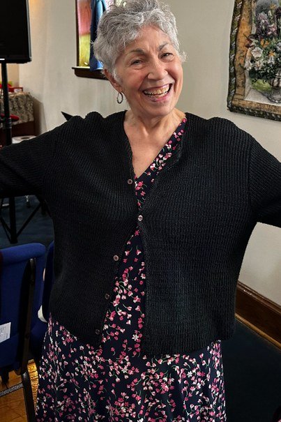 Black cardigan with floral dress, interior for women over 60