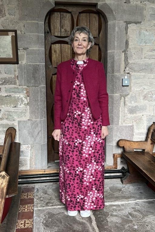 Magenta cardigan with pink floral maxi skirt, stone church for women over 60