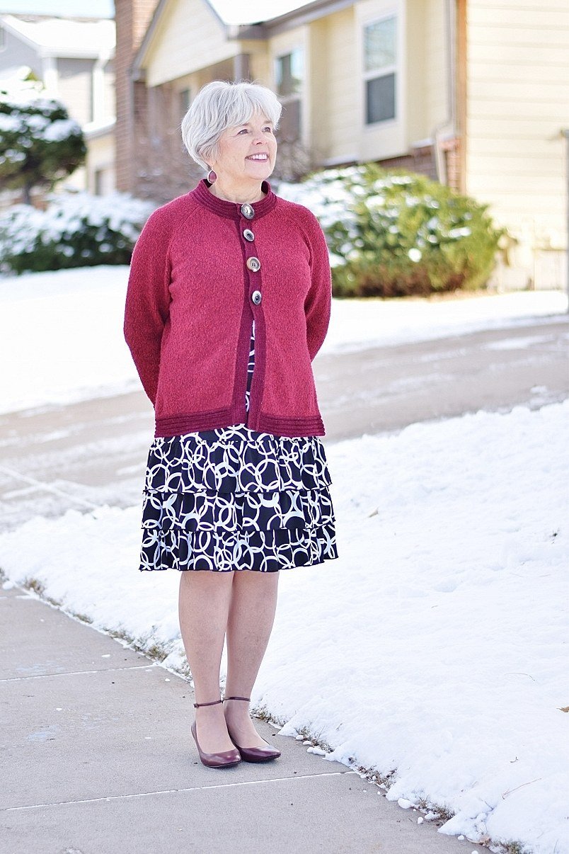 Red cardigan with floral skirt, snowy street for women over 60