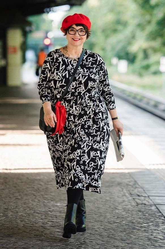 Black-and-white floral midi dress + red beret + black boots, railway walkway - classy outfit for women over 40